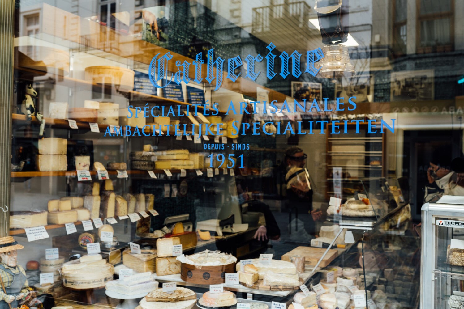 واجهة عرض Fromagerie Catherine في rue du Midi ببروكسل، مع الأجبان واسم المتجر.